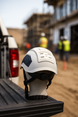 Type 2 Class E Hard Hat displayed on a truck bed, showcasing its sturdy design and construction site setting.